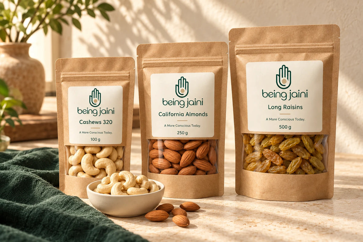 Being Jaini Cashews 320, California Almonds and Long Raisins in the original kraft window pouches — illustrative packaging scene