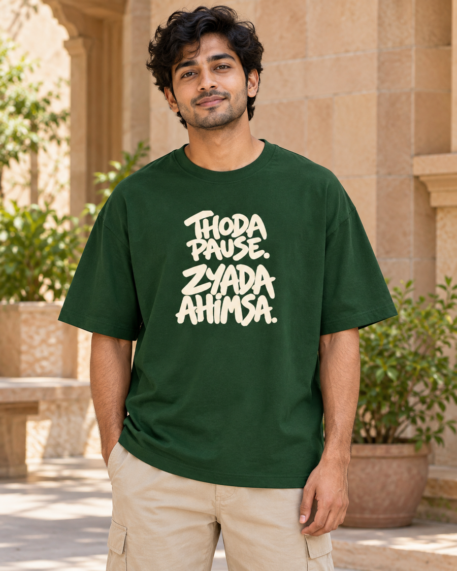 Thoda pause. Zyada ahimsa. — front view · Bottle Green oversized T-shirt · Styling illustration.