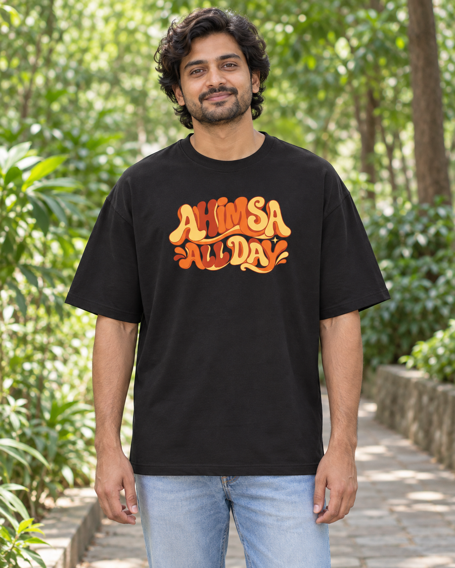 Ahimsa all day — front view · Black oversized T-shirt · Styling illustration.