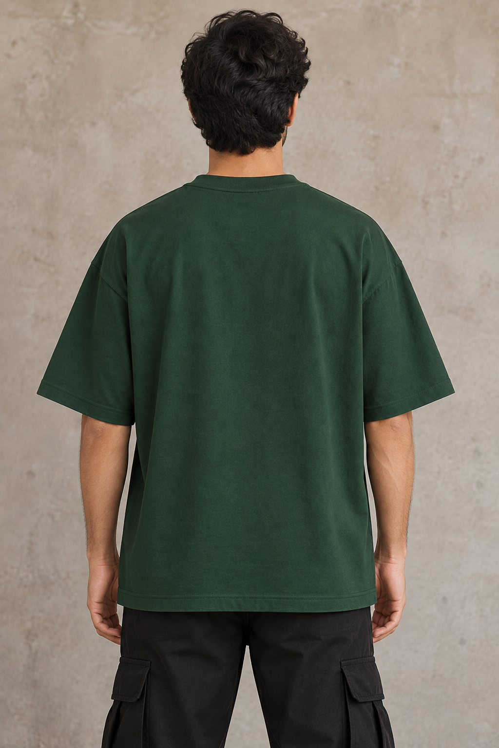 Styling illustration · plain back view · Bottle Green Qikink UC22 oversized T-shirt on an Indian adult model. Shared view of the same unprinted garment surface; not a produced-sample photograph.