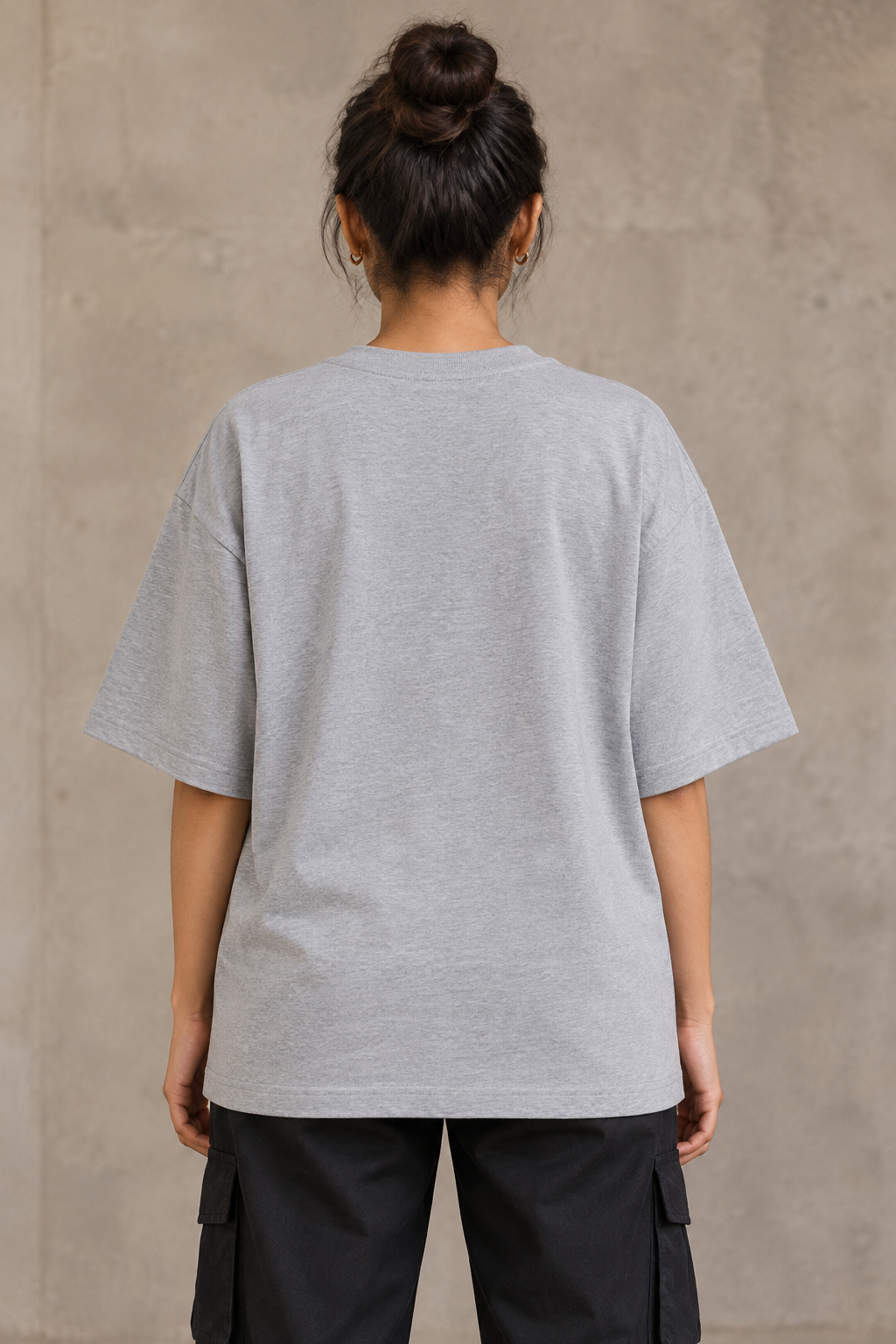 Styling illustration · plain back view · Grey Melange Qikink UC22 oversized T-shirt on an Indian adult model. Shared view of the same unprinted garment surface; not a produced-sample photograph.