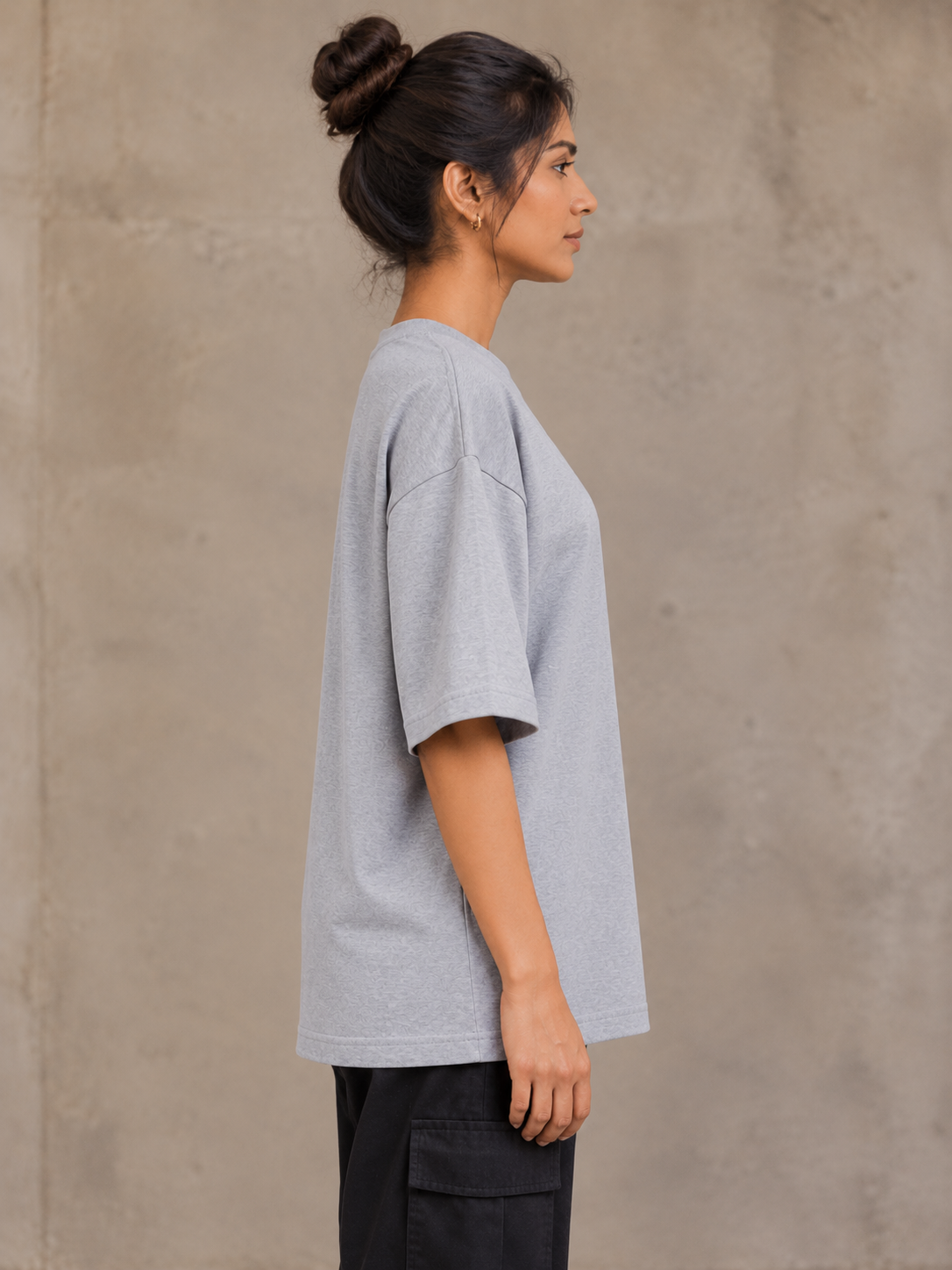 Styling illustration · right side profile · Grey Melange Qikink UC22 oversized T-shirt on an Indian adult model. Shared view of the same unprinted garment surface; not a produced-sample photograph.
